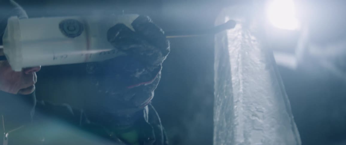A man pours liquid on an ice sculpture