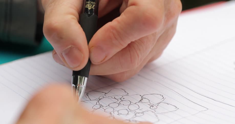 A man sketching in a notebook