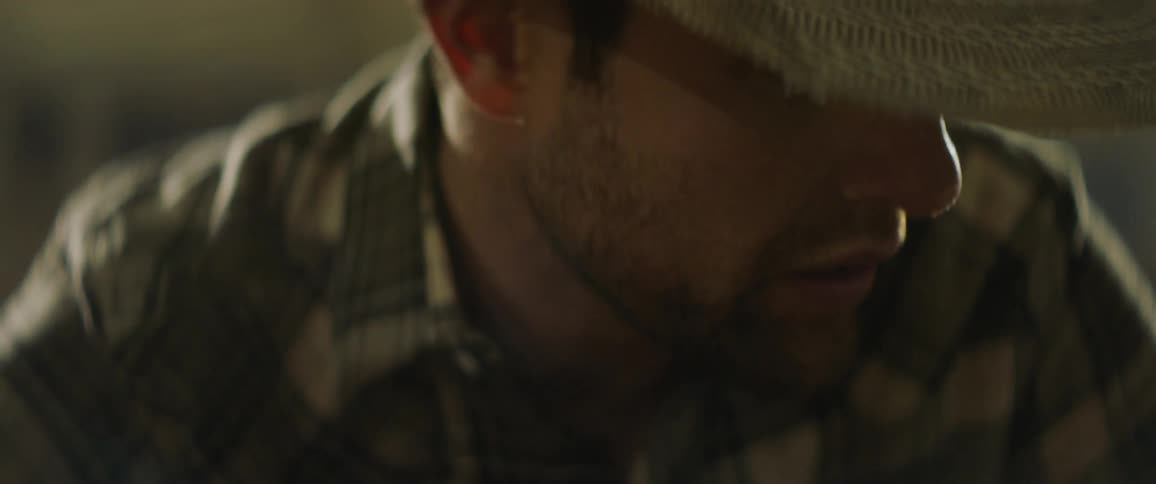 A man in a cowboy hat speaks