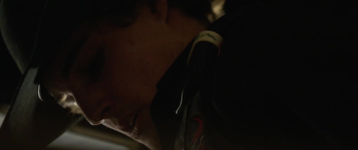 A rodeo cowboy is nodding and breathing deeply