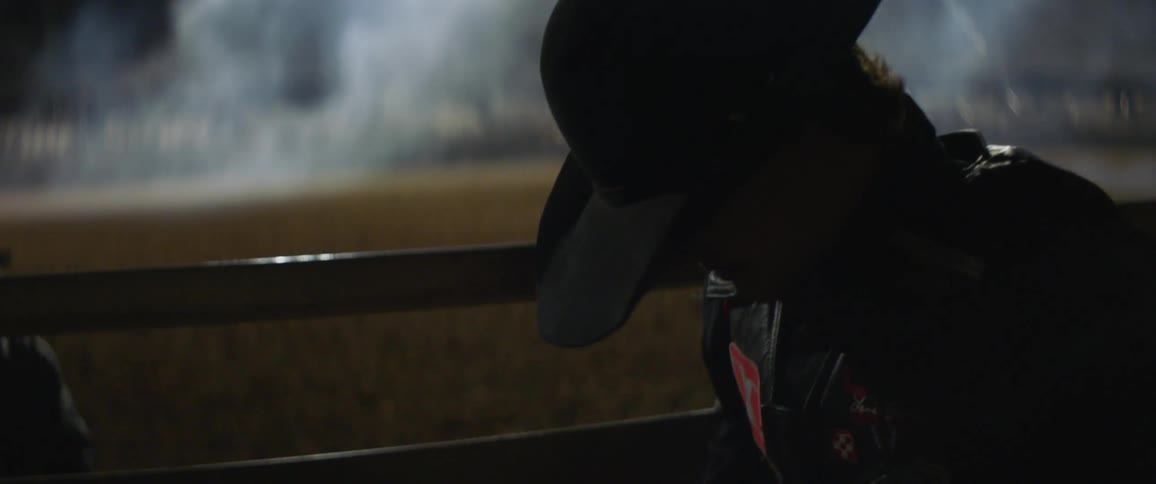 A rodeo cowboy gets ready to ride