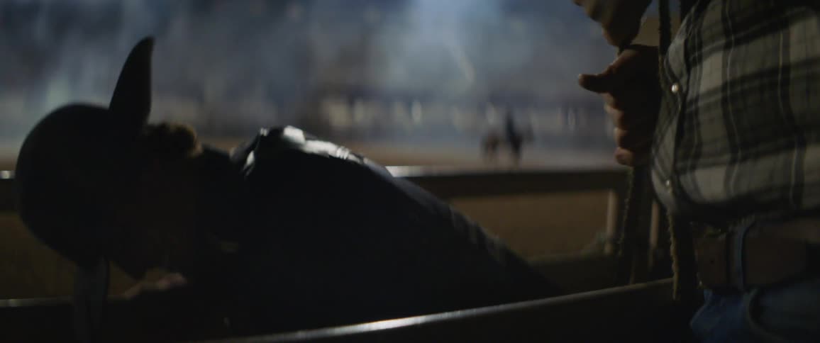 A rodeo cowboy prepares to ride