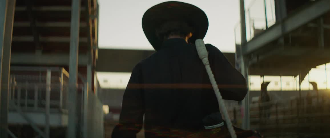 A man carries a saddle