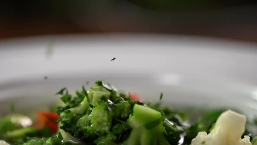 Garnish is dropped on the dish