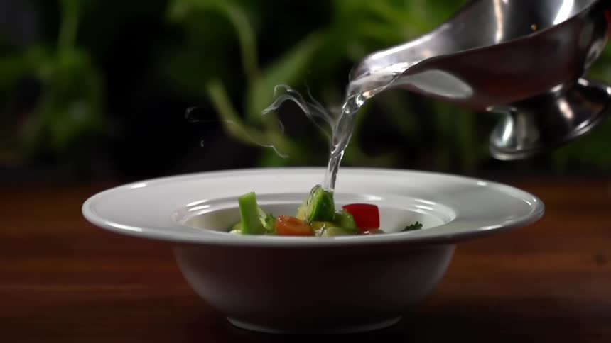Boiling water is poured over vegetables