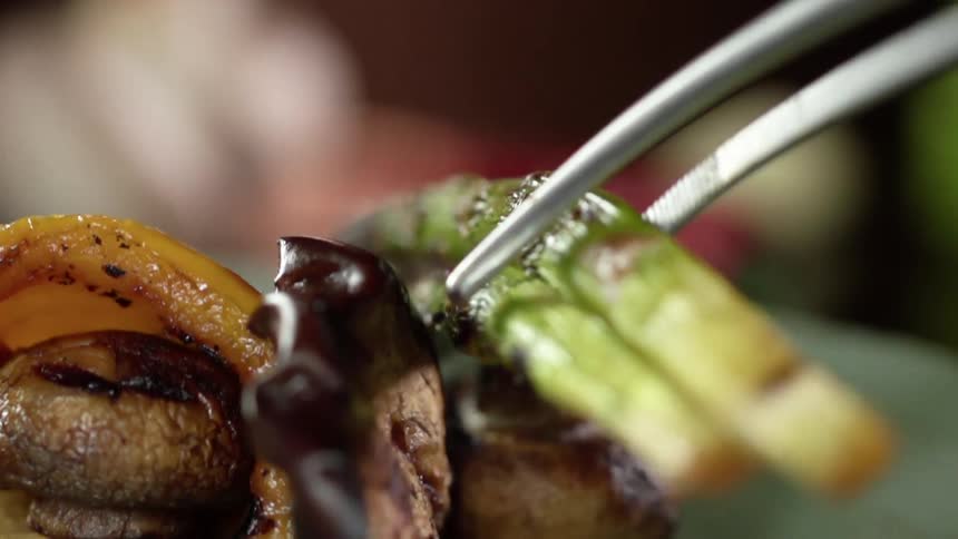 Grilled asparagus is put on the vegetarian dish