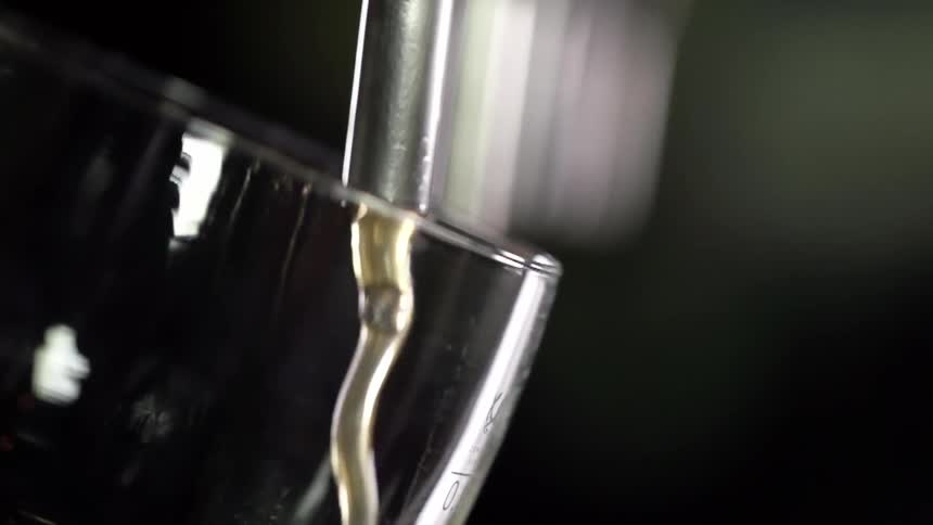 A glass is being filled from the tap