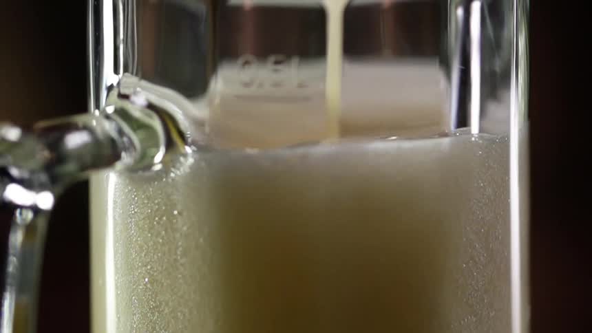 Beer fills a glass mug