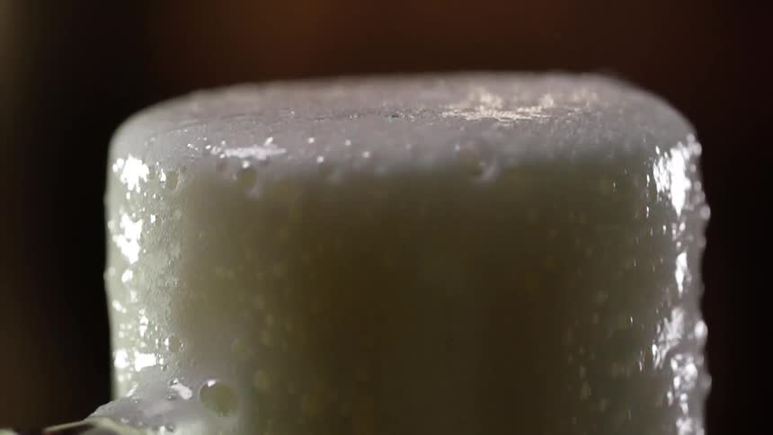 White liquid overflows a container