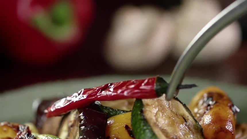 A pepper is placed on top of vegetables