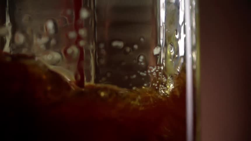 A drink being poured in to a glass