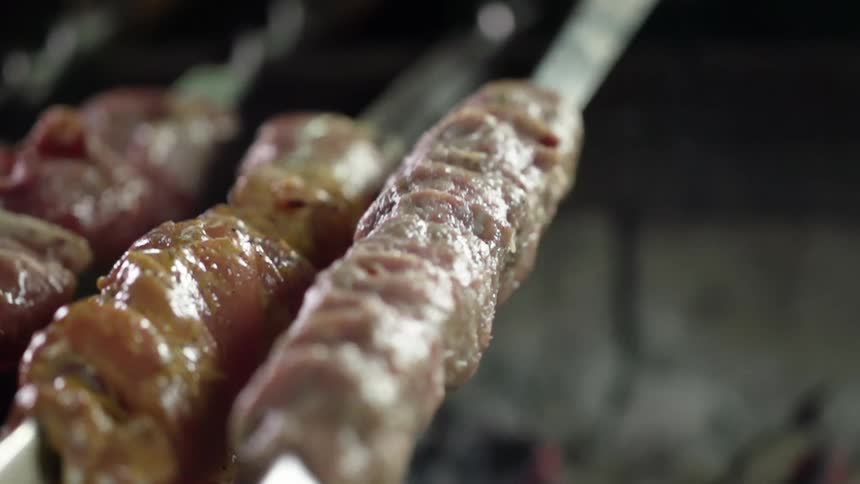 Meat on a stick placed over hot barbecue coals
