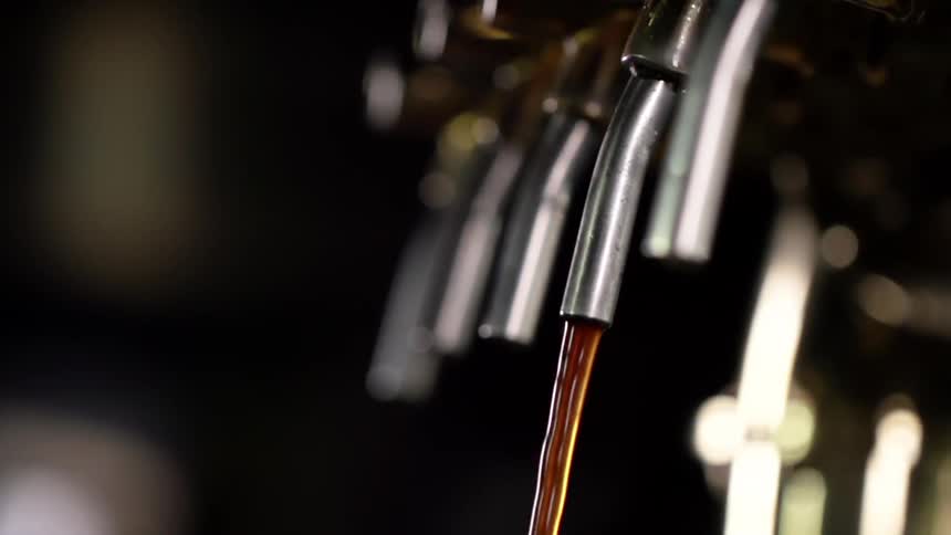Beer coming out of a beer tap at a bar