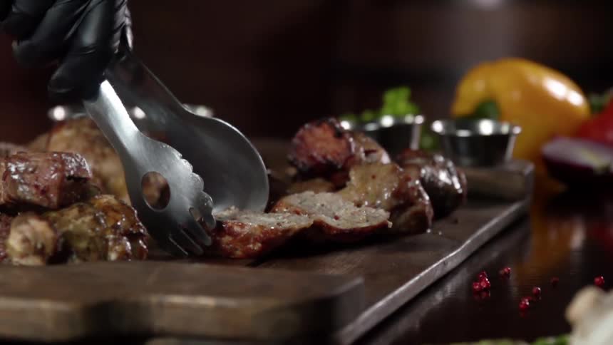 A slice of meat is placed on the cutting board