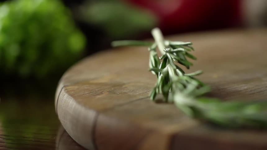 A vegetable is dropped on the cutting board