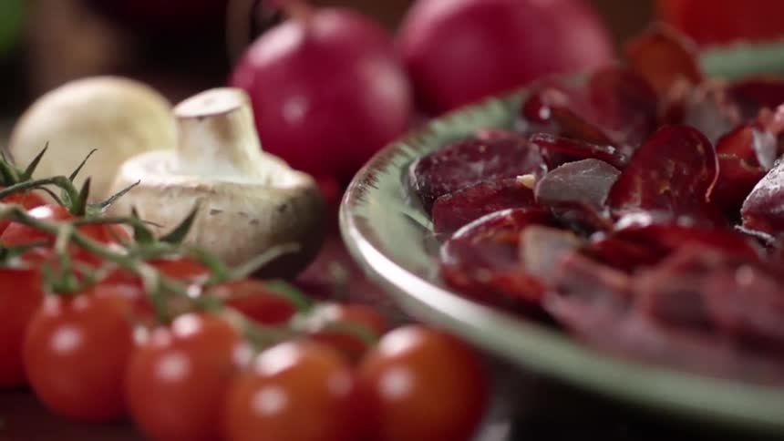 Vegetables and mushrooms surround a plate of food
