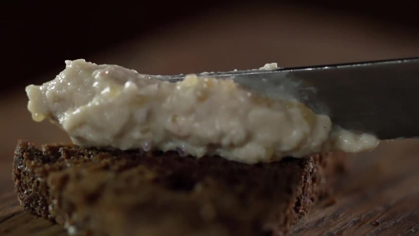 Food is being spread with a butter knife