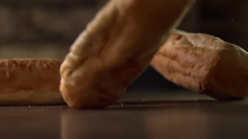 Loaves of bread are dropped on the table