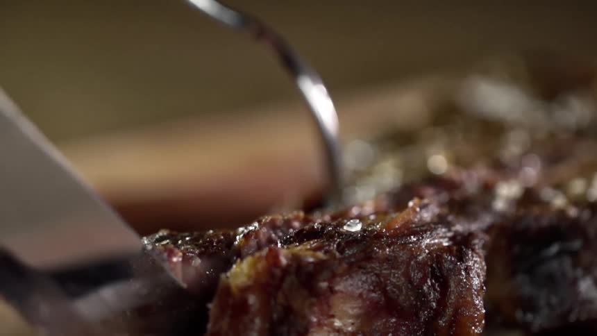 A person cuts in to a steak