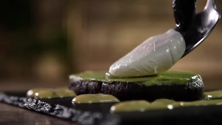 A mozzarella medallion is placed on a patty topped with a green puree