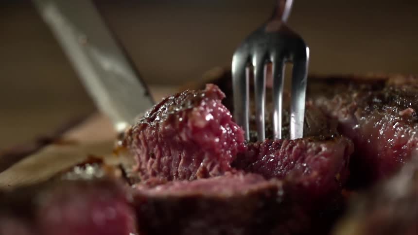 A person cuts in to a steak