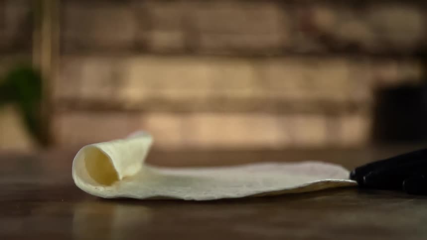 The cook unrolls lahvash on the counter