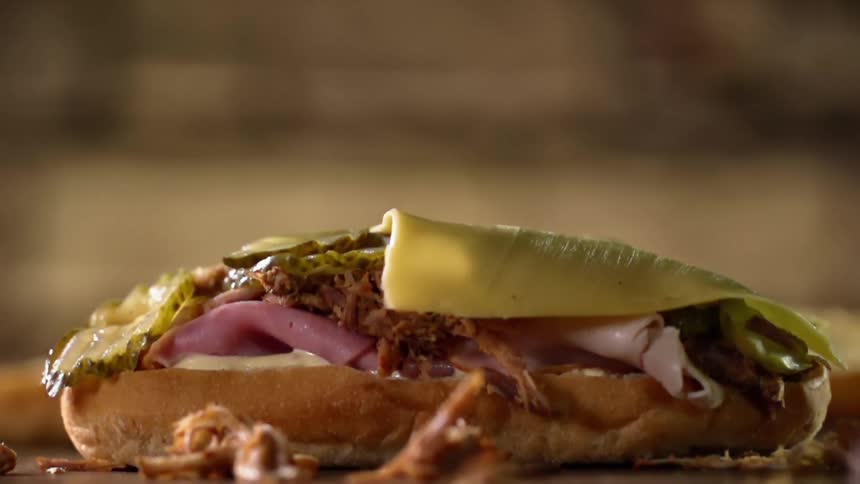 Cheese falling on to a sandwich