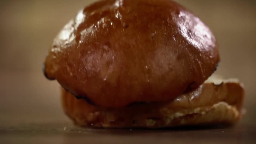 A grilled bun drops on to a counter