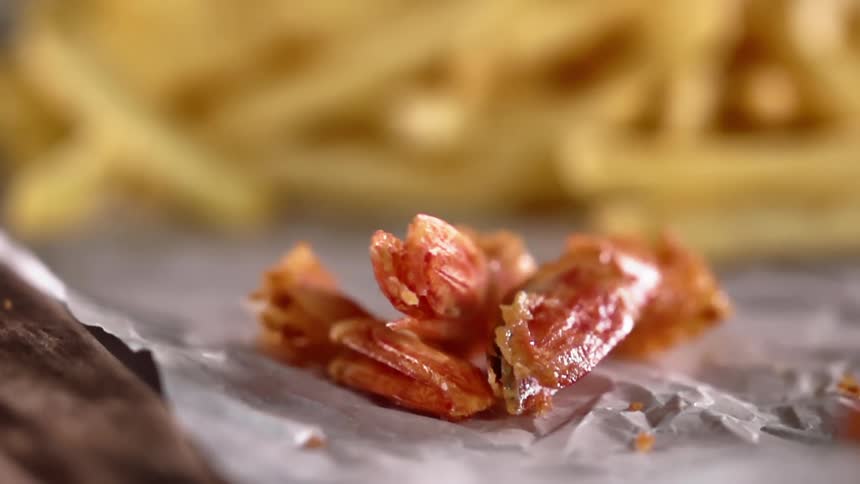 The ends of fried shrimp thrown on paper