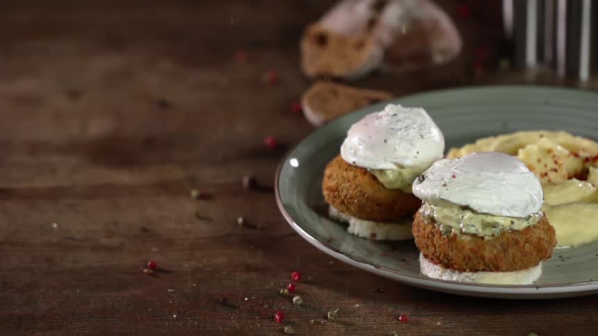 Bits of seasoning falling over a fancy dish