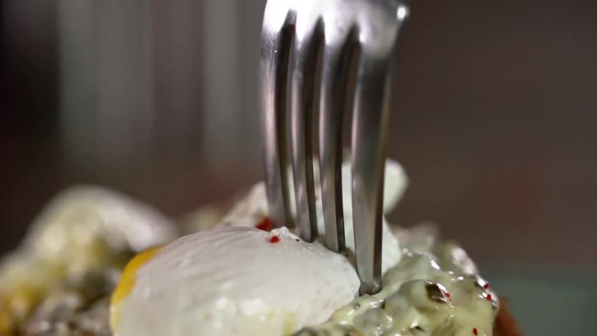 Metallic fork pinches cream covered food
