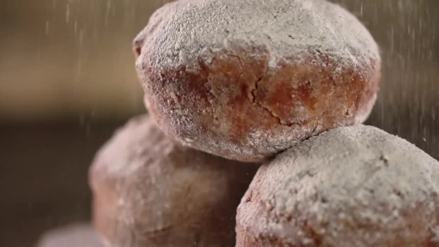 Powdered sugar is sprinkled on donut holes