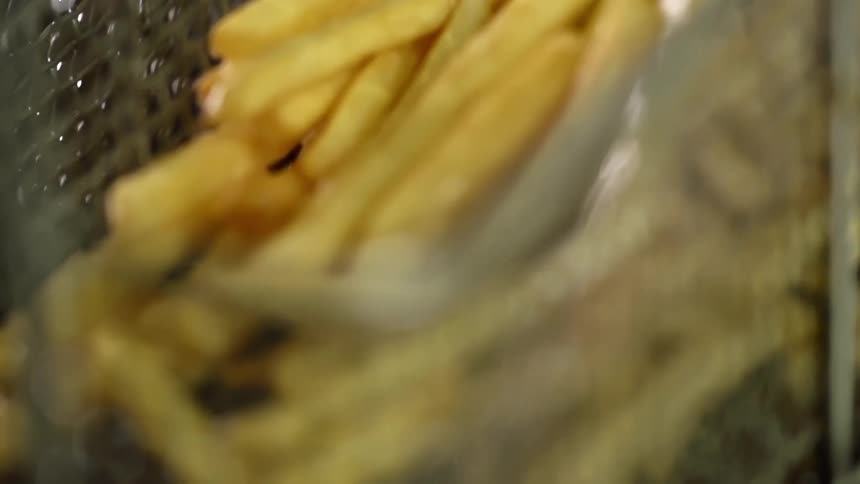 French fries inside a deep frying metal basket