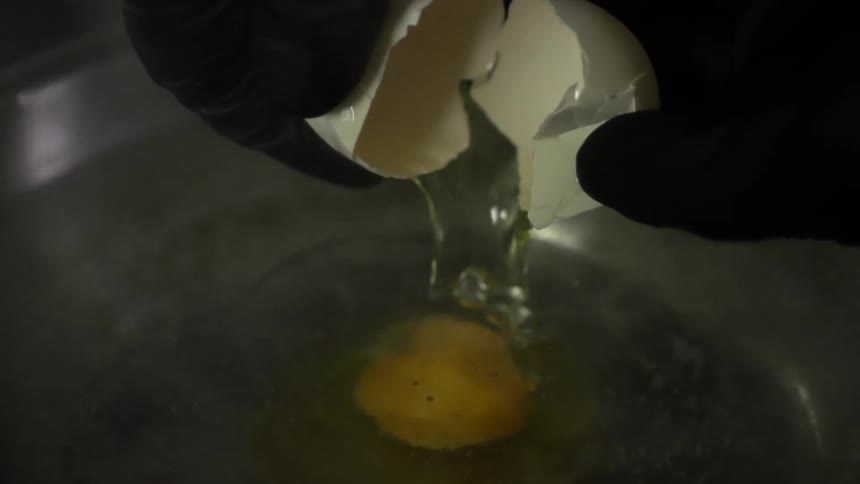 An egg is cracked into a bowl