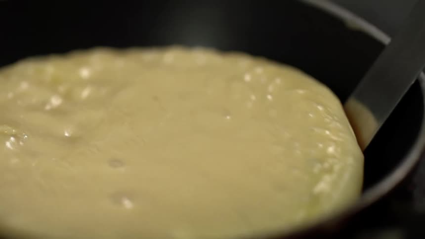Spatula lifts a pancake from a pan
