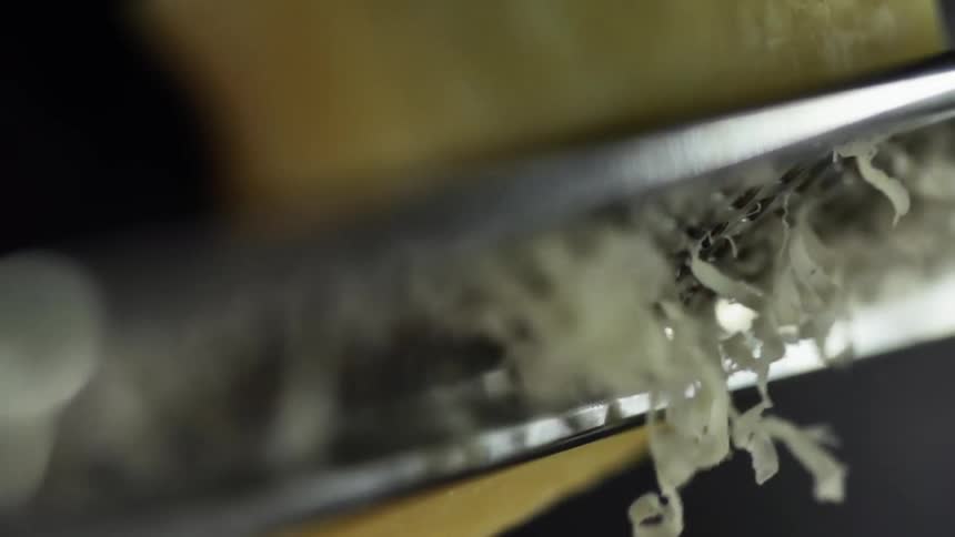 Parmesan cheese is grated on a microplane