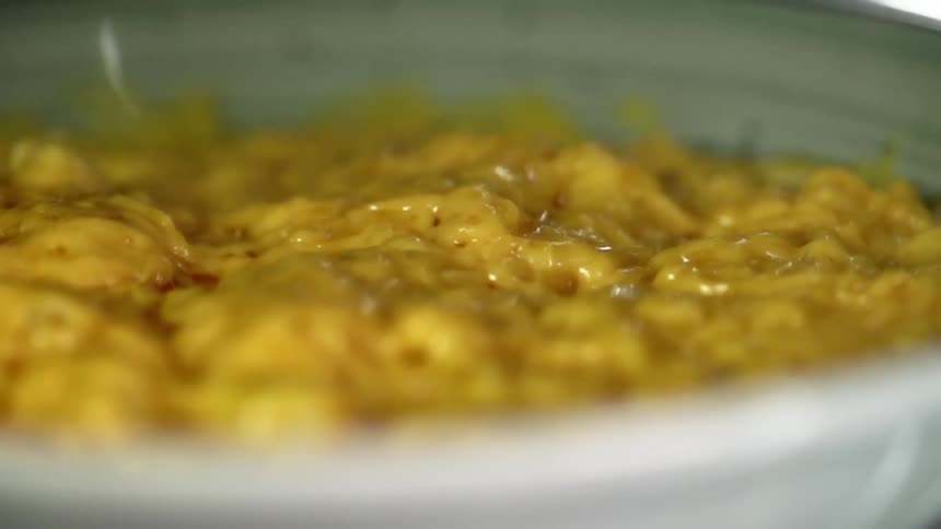A dish with yellow food is on the table