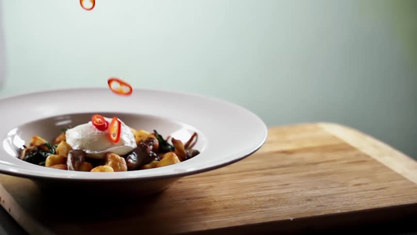 Peppers are dropped on the top of a meal as a garnish