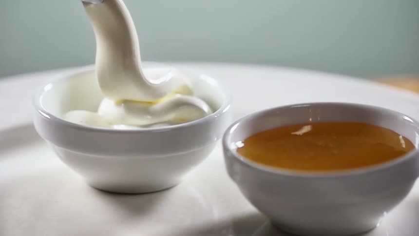 Cream being put in a small bowl