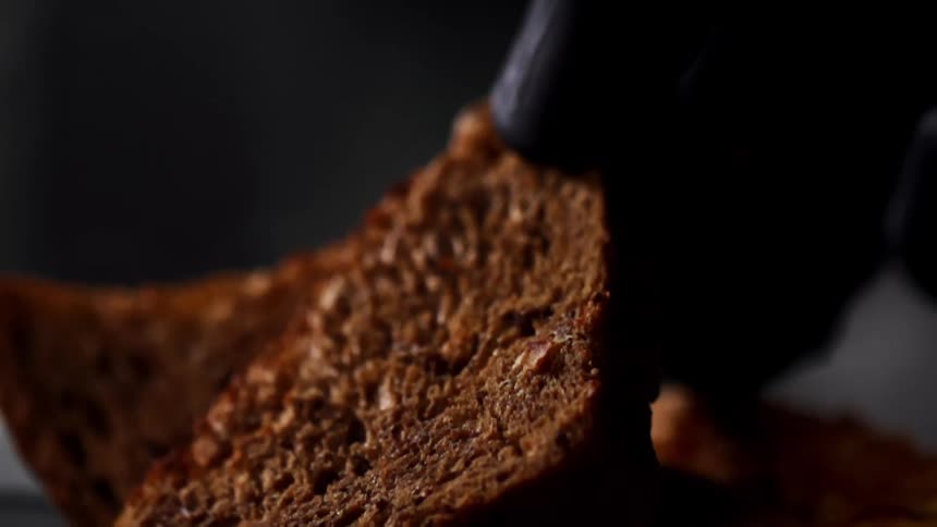 Slices of brown toasted bread on a dish near food