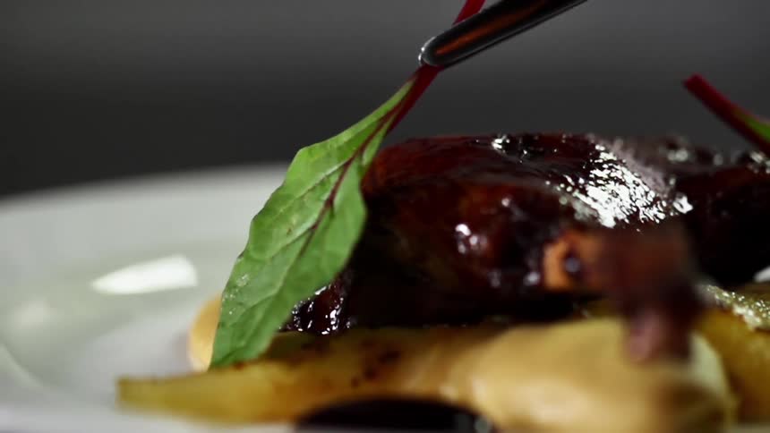 A garnish is put on the meat