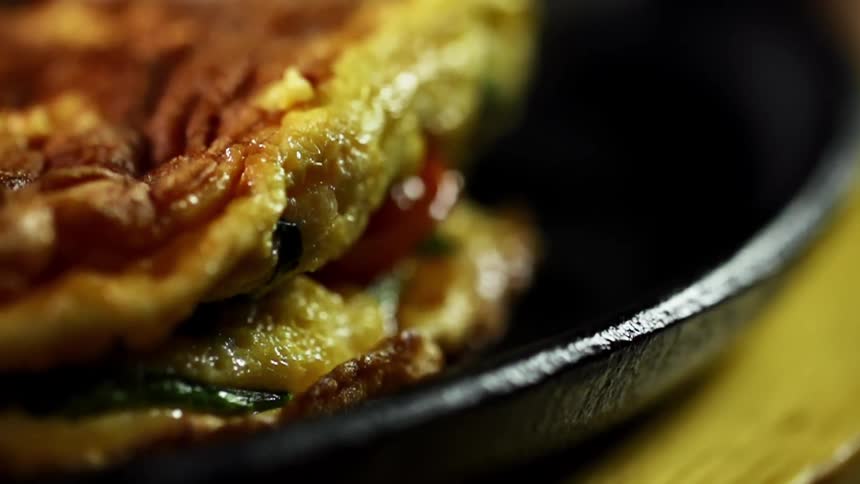 An omelette is flipped in the pan