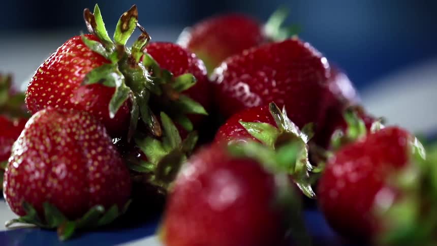 Fresh strawberries on a blue and white surface