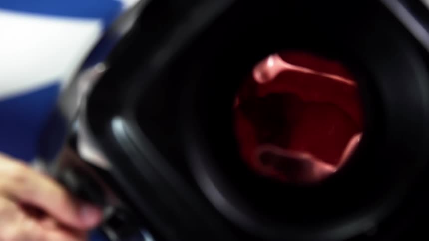 A person turning on a blender on a table