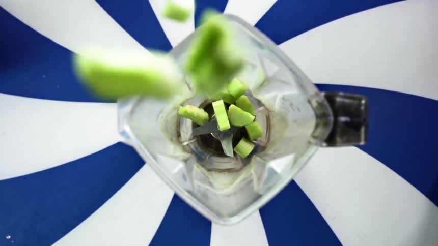 Birds eye view of celery going in to a blender