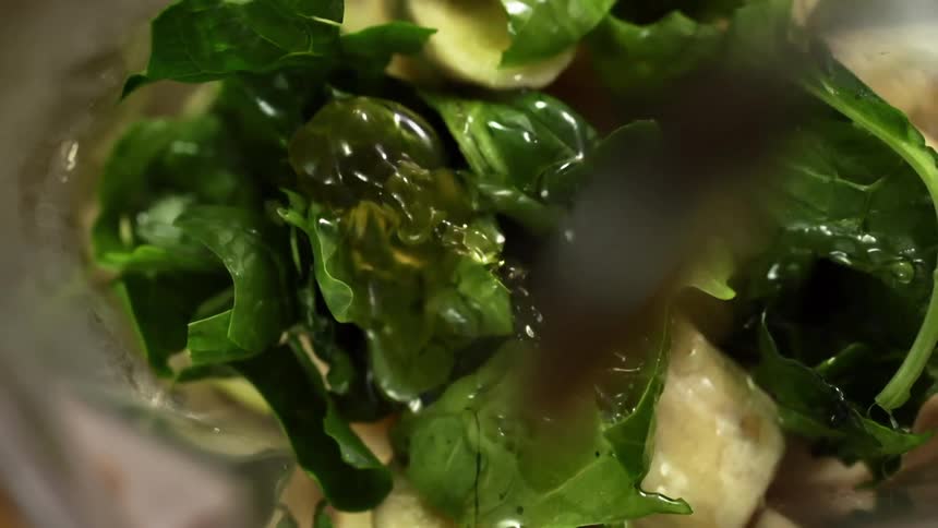 Oil is drizzled on the salad