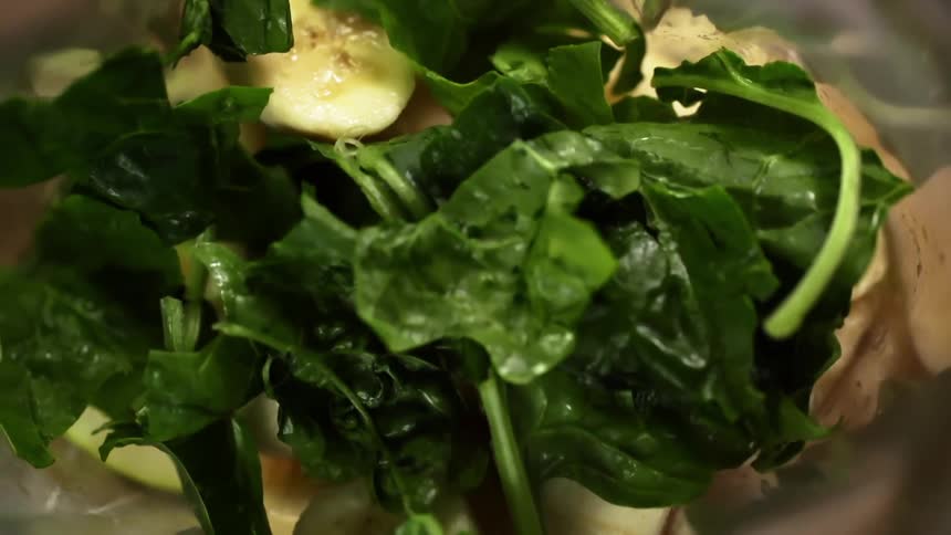 Bananas apples and spinach in a blender