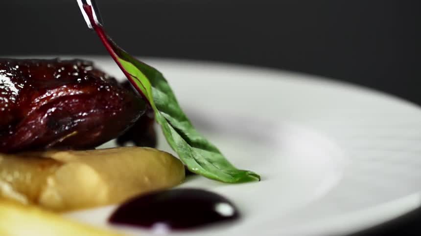 A garnish is placed on the dish