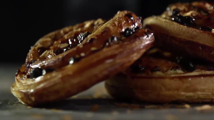 A pastry falls on to a counter with other pastries