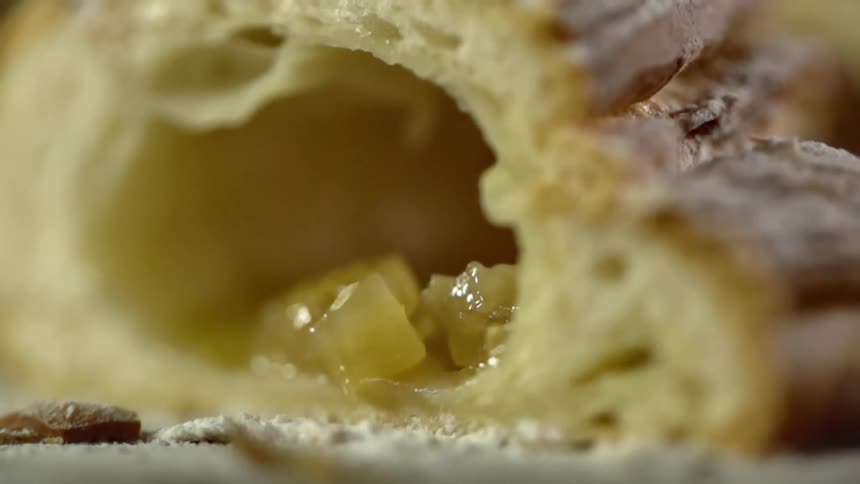 Pieces of cooked apple sit inside a pocket in a turnover